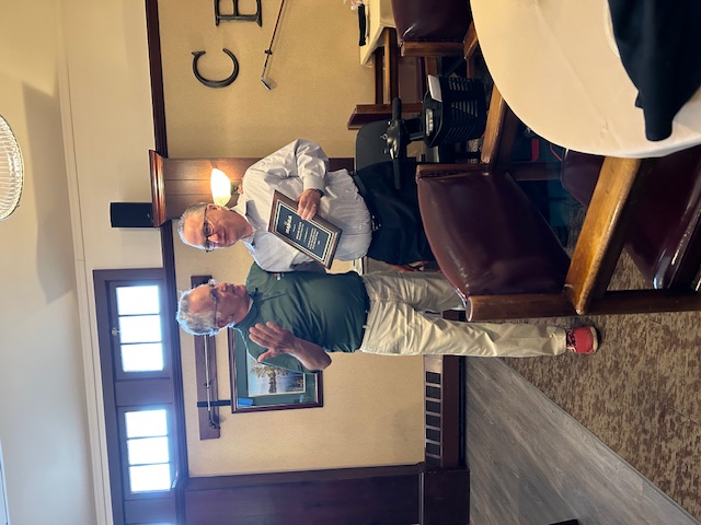 Paris Sterrett, Second Vice President of the Middle Atlantic Blind Golf Association (MABGA), presents a wooden-framed plaque with a black plate and silver lettering to Brian Farrell, the golf professional at Brookside Country Club, during the MABGA golf outing on May 11, 2023. The plaque is presented in recognition of Brookside Country Club’s continued support in hosting golf outings for MABGA.