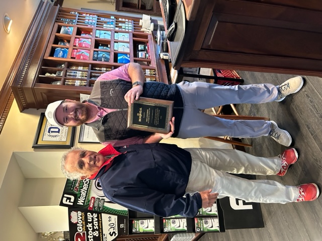 Paris Sterrett, MABGA 2nd Vice President, and Cameron Takacs, Assistant Pro at Downingtown Country Club, holding a plaque presented on April 17, 2023, during the MABGA outing at Downingtown Country Club.